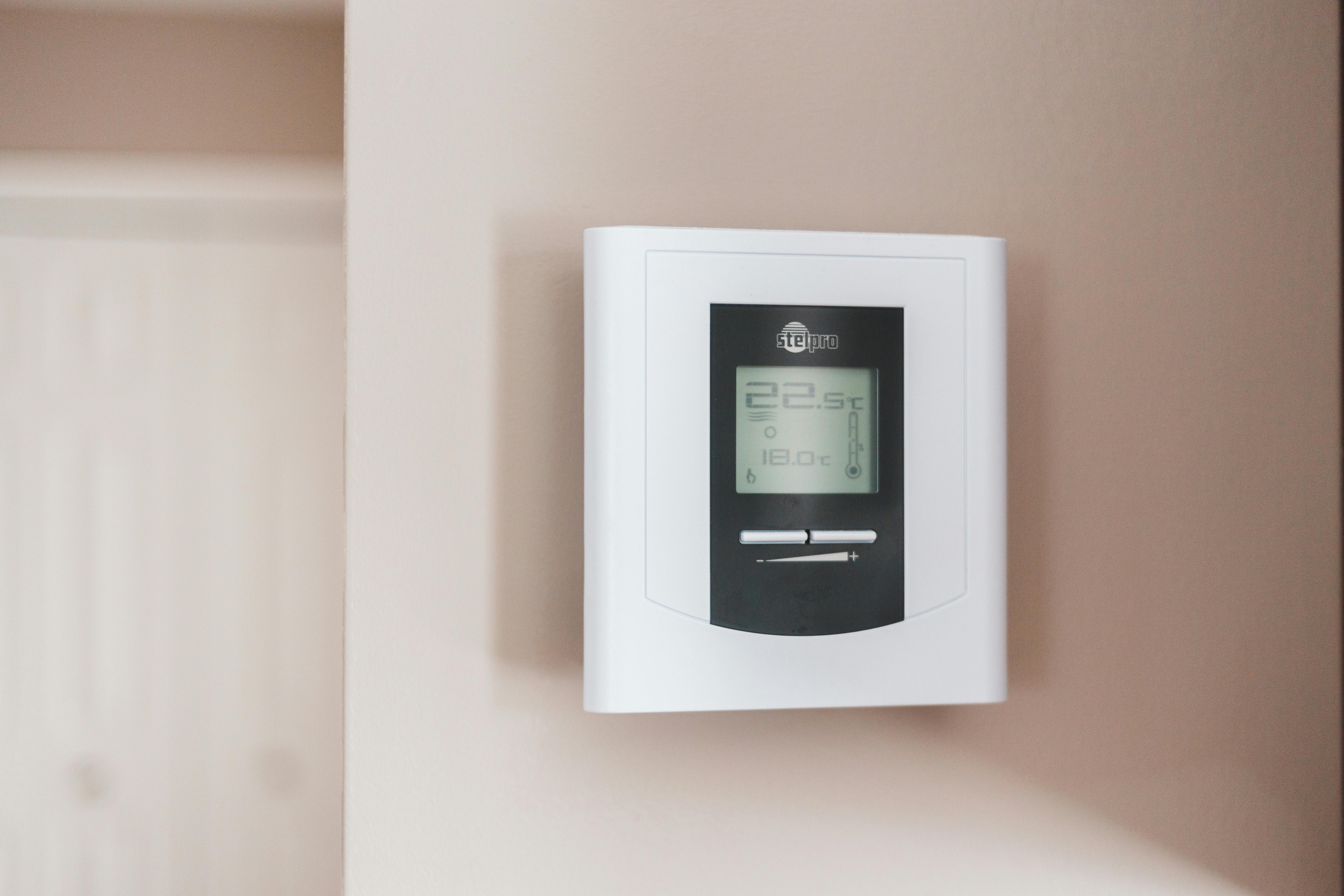 Modern smart thermostat installed on a clean wall