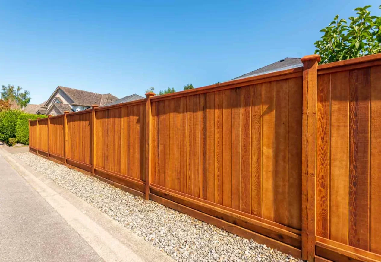 A finished cedar wood board-on-board fence
