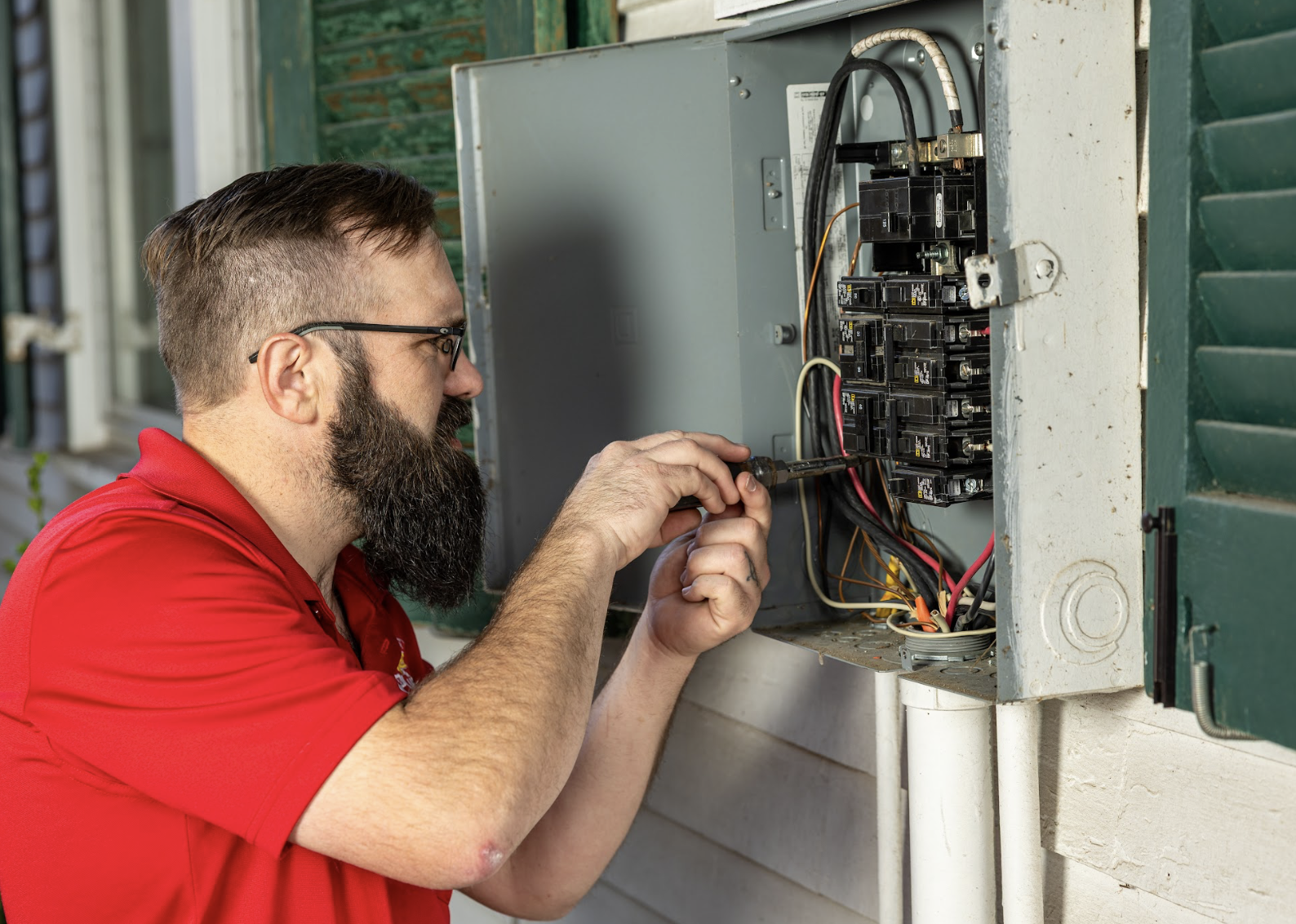 Sinclair electrician working on an outdoor electrical panel
